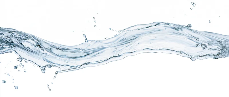 Dynamic wave of clear water frozen mid-splash flowing horizontally against white background
