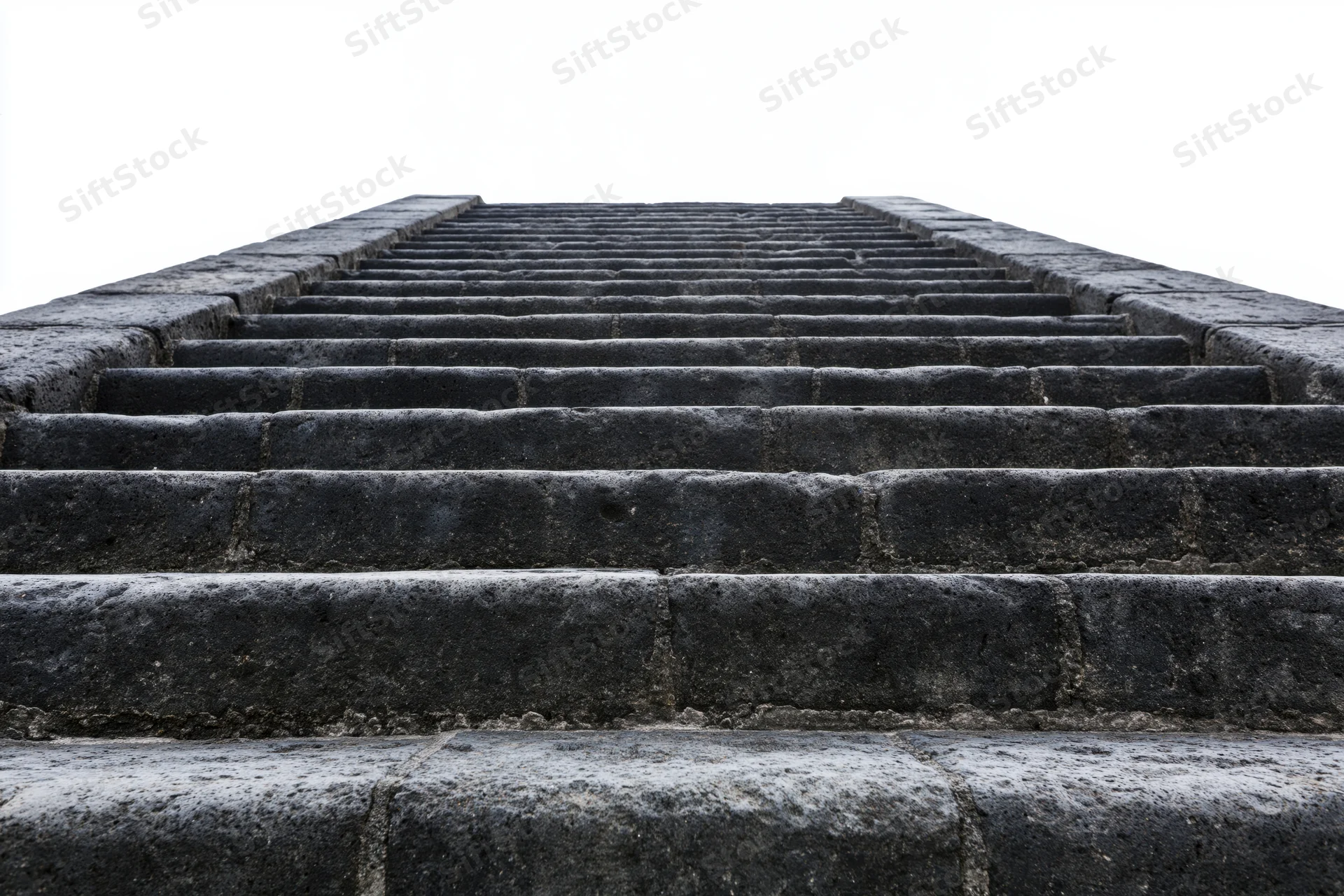 Wide stone staircase ascending upward from low angle view