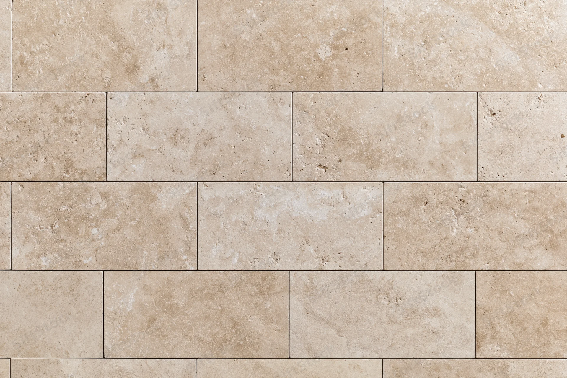 Travertine stone tiles arranged in a rectangular pattern on a wall surface