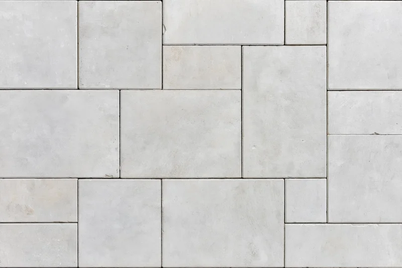 Close-up of concrete pavers arranged in a herringbone pattern for outdoor flooring