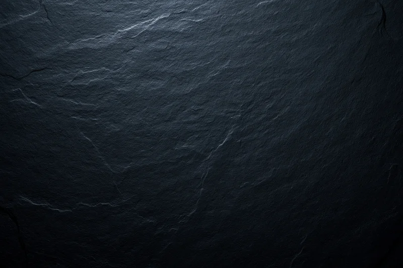 Close-up of dark slate stone surface with natural texture and cracks