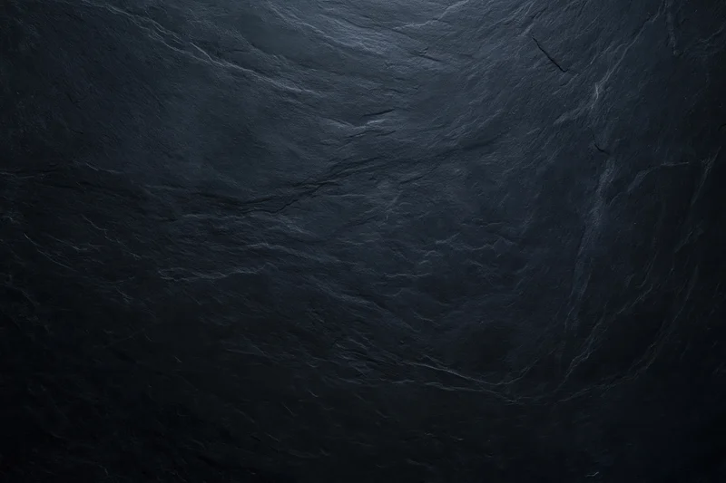 Close-up of dark slate stone surface with natural texture and veining