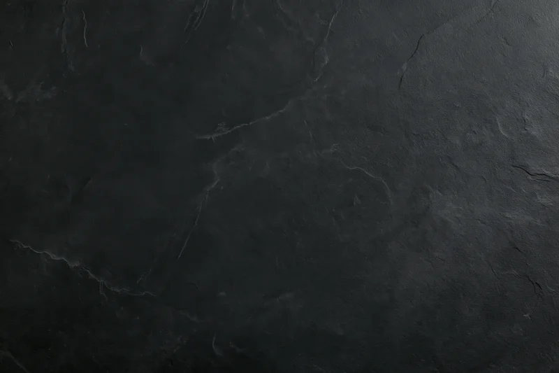 Close-up of dark slate stone surface with natural veining and texture