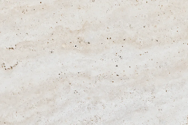 Close-up of honed travertine marble surface with natural veining and speckles