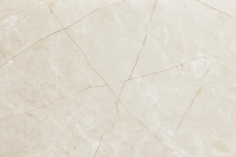 Close-up of polished cream marble surface with natural veining filling the frame