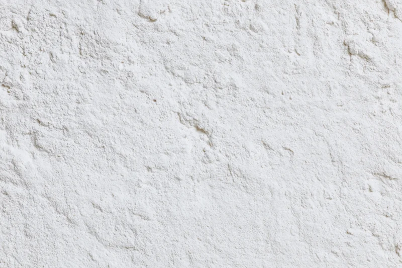 Close-up of rough white plaster wall surface filling the frame
