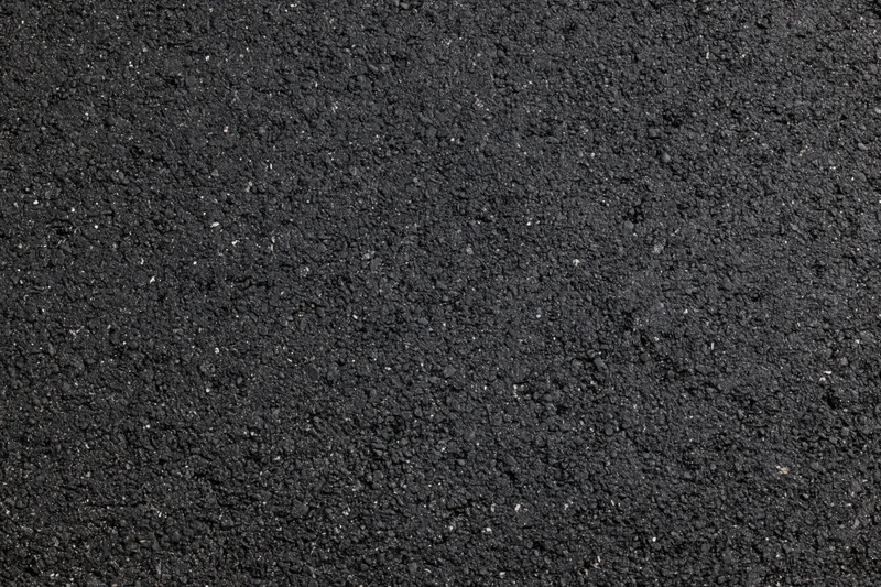Close-up of dark asphalt road surface texture filling the frame