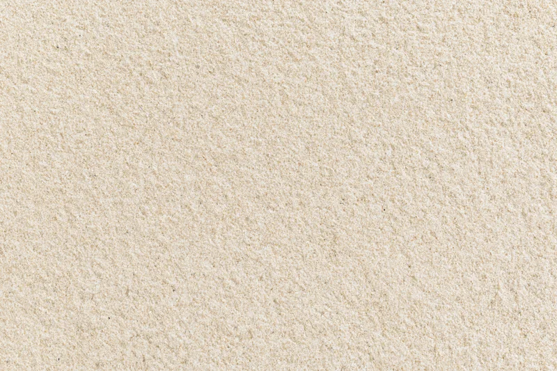 Close-up flat lay of dry beach sand filling the entire frame