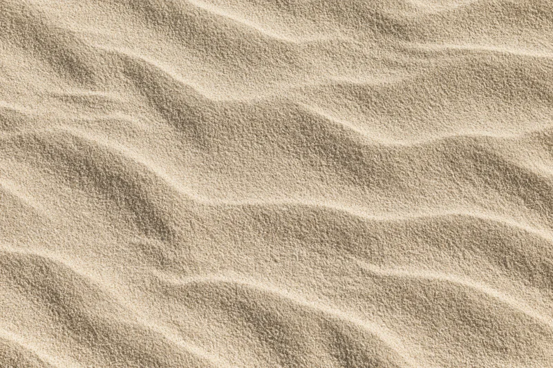 Close-up of rippled dry beach sand filling the frame
