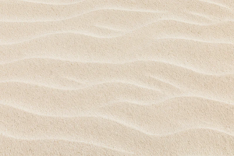 Close-up of wavy dry beach sand filling the frame
