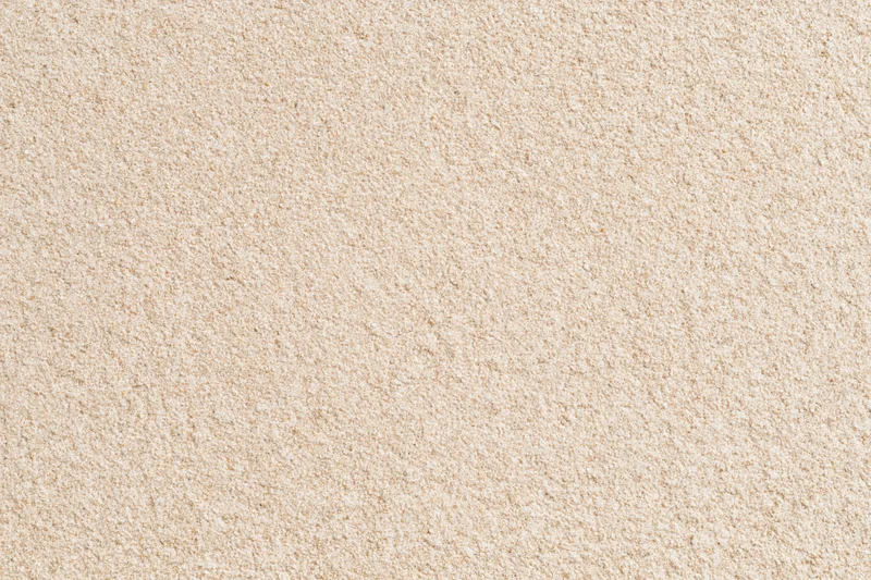 Close-up flat lay of dry beach sand filling the entire frame