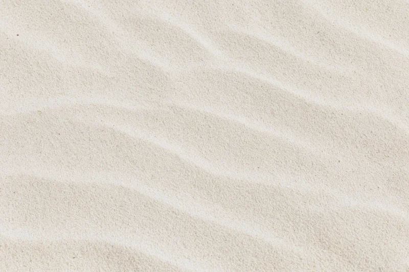 Close-up of rippled dry beach sand surface in flat lay view