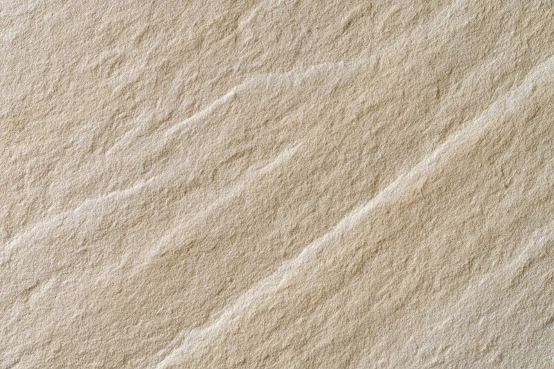 Close-up of natural sandstone rock surface showing layered texture and sedimentary patterns