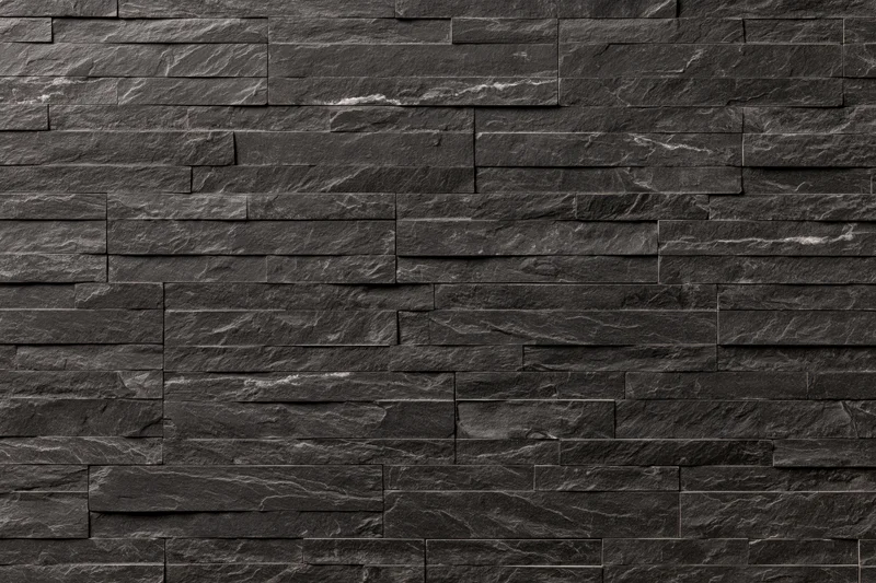 Stacked slate stone tiles arranged in horizontal layers on a wall surface