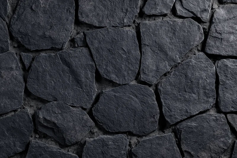 Close-up of dark irregular slate stone wall surface