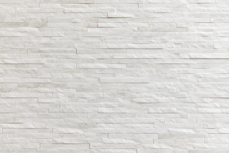 Close-up of a modern stacked stone tile wall in white marble finish