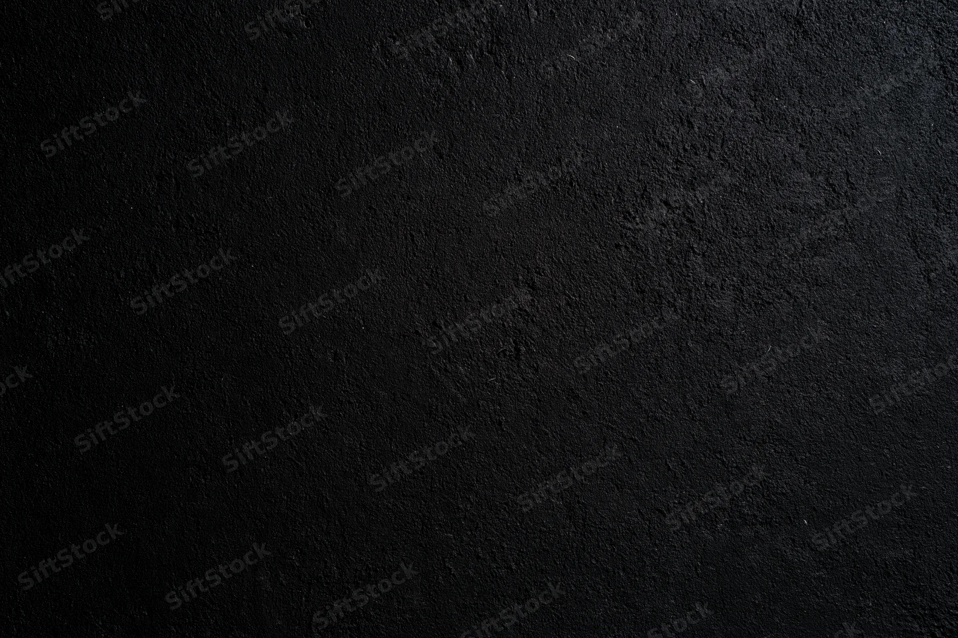 Close-up of rough dark concrete wall surface