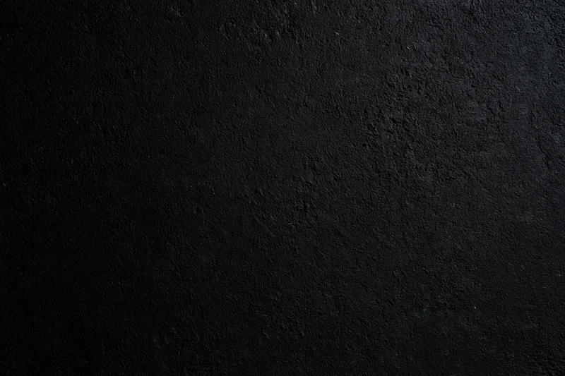 Close-up of rough dark concrete wall surface