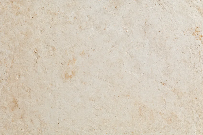 Close-up of a weathered plaster wall with natural texture and subtle discoloration
