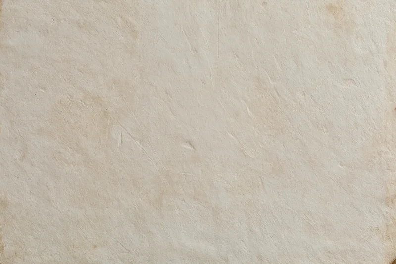 Close-up of a weathered plaster wall surface with natural texture and subtle cracks