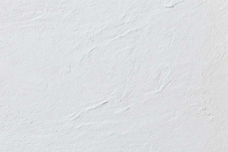 Close-up of white plaster wall surface with textured finish