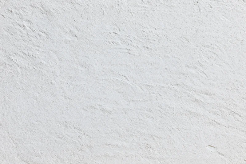 Close-up of white plaster wall surface with textured finish