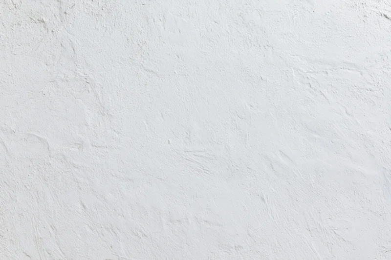 Close-up of white plaster wall surface with textured finish