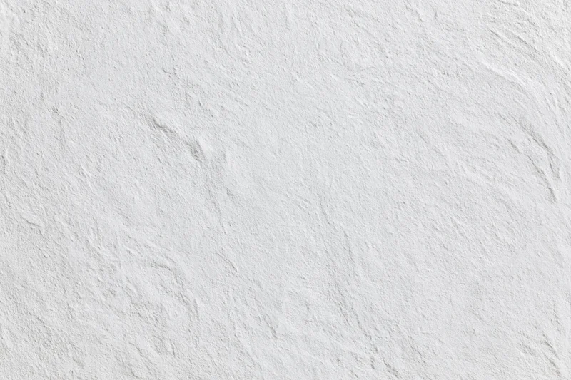 Close-up of white rough plastered wall surface