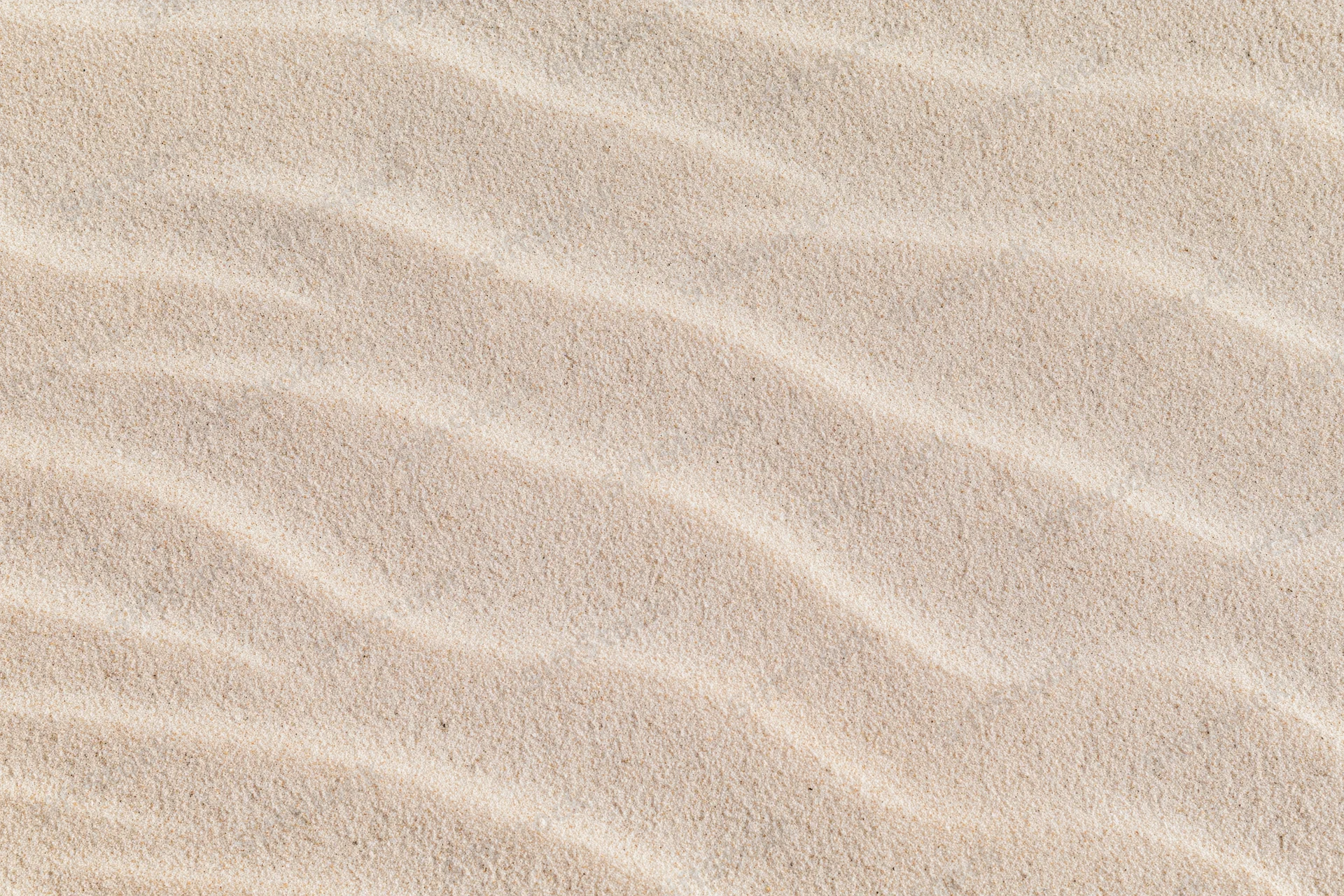 Close-up overhead view of rippled dry beach sand surface