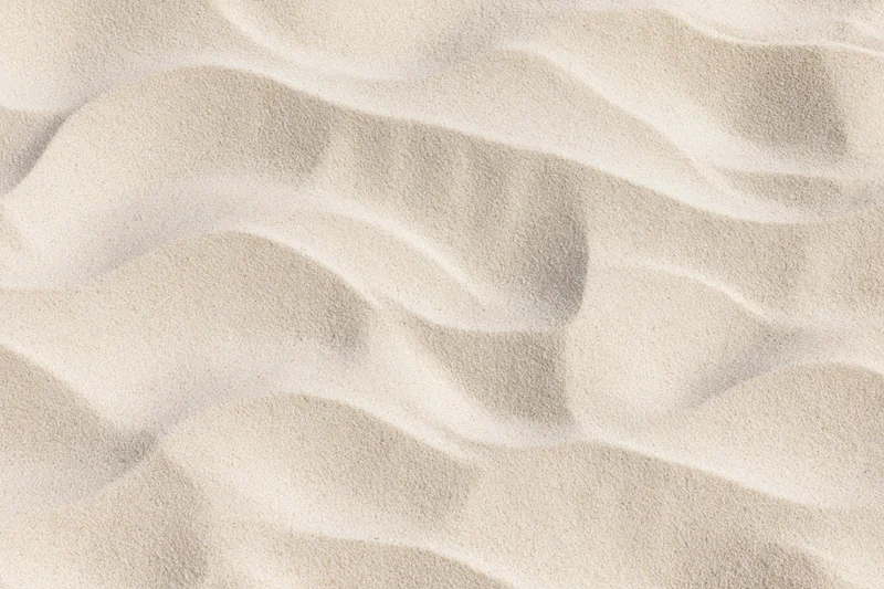 Close-up overhead view of rippled dry beach sand surface