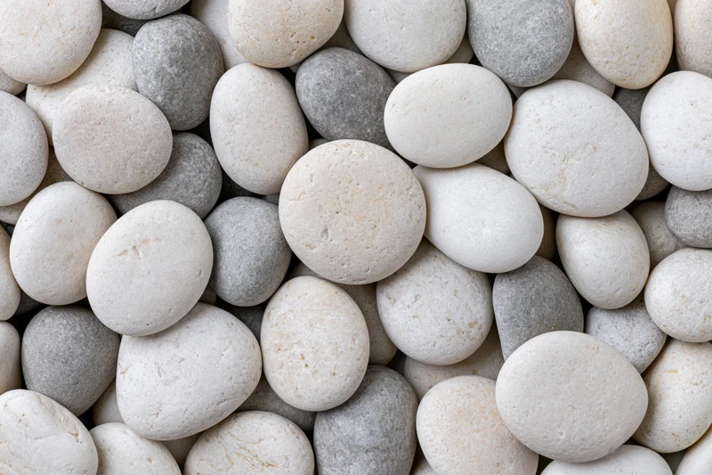 Smooth rounded pebbles in a dense overhead closeup filling the frame