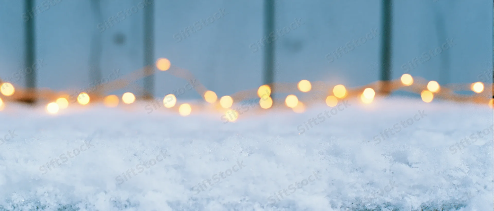 Snow surface with glowing string lights in winter outdoor setting