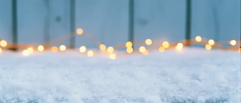 Snow surface with glowing string lights in winter outdoor setting