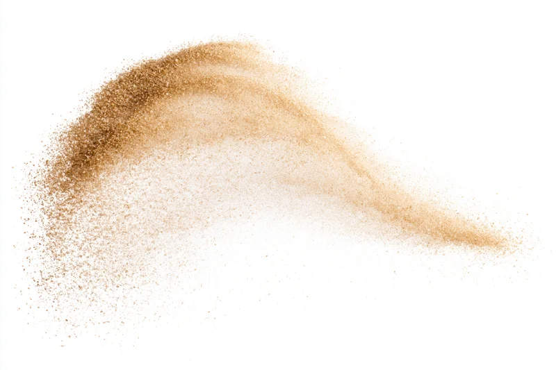 Golden-brown sand particles mid-explosion frozen in motion against white background