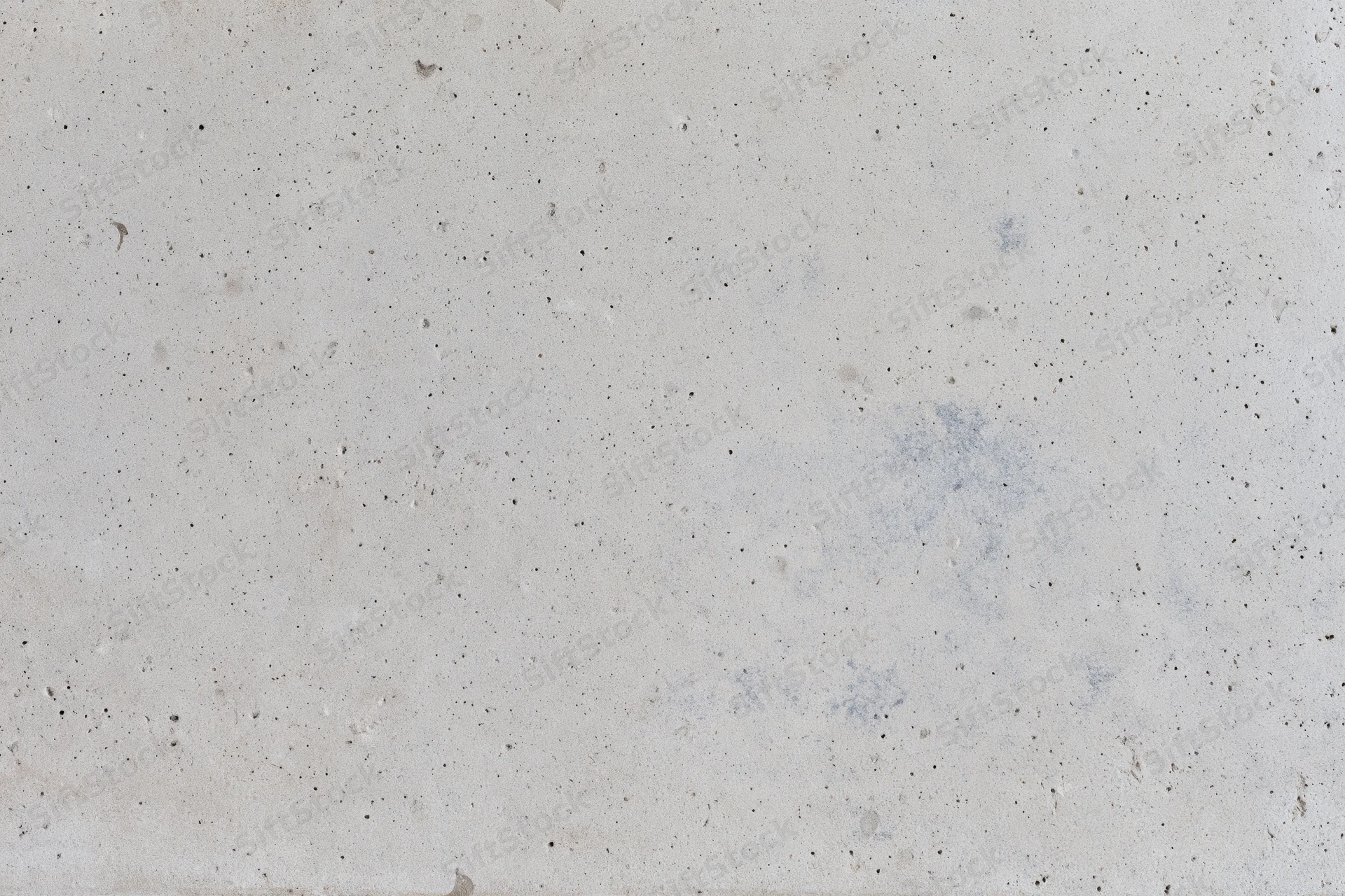 Flat concrete surface with speckled texture and faint stains, full-frame view