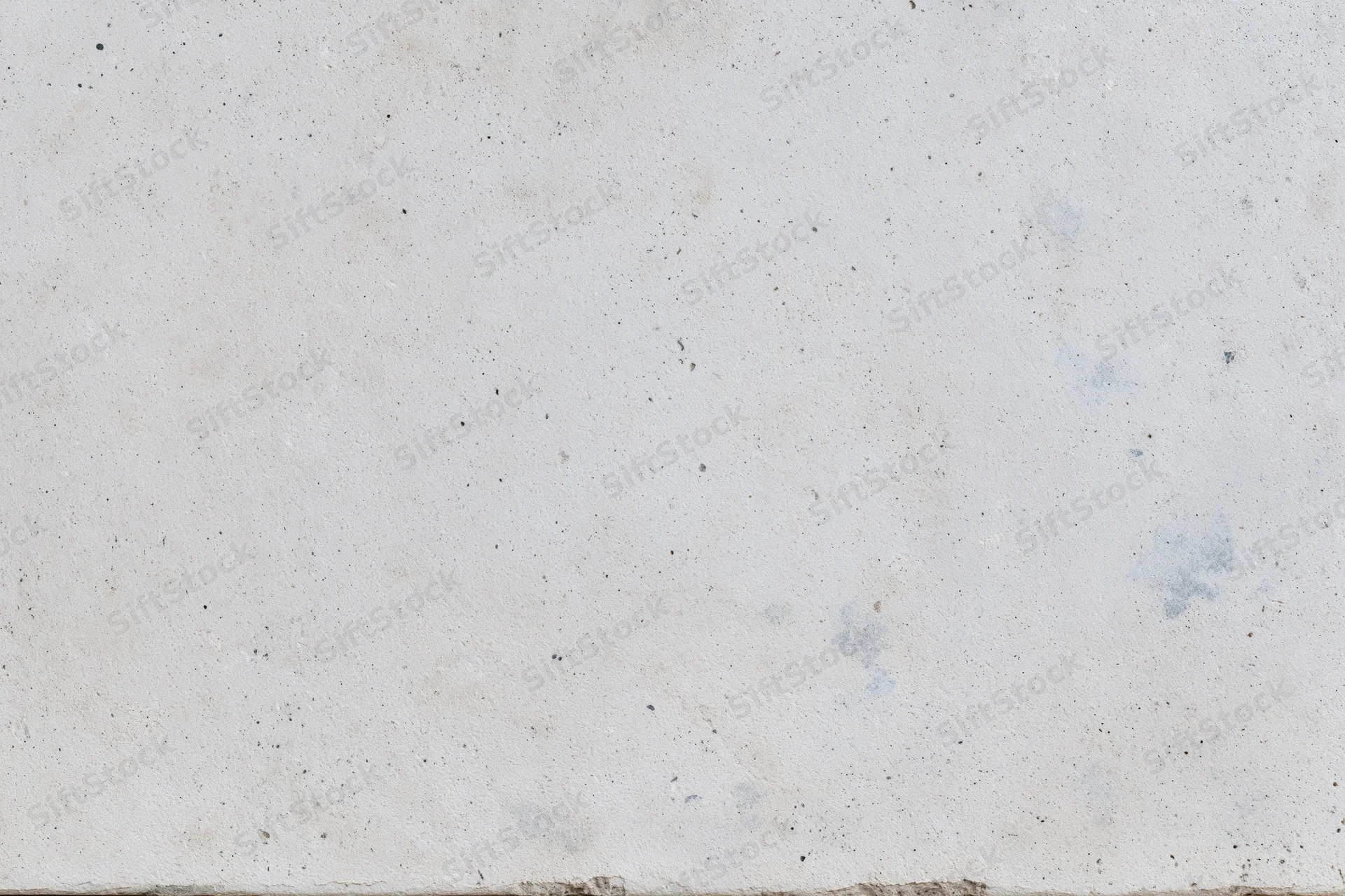 Flat concrete surface with speckled texture and minor stains filling the frame