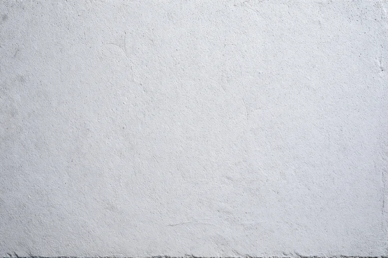 Close-up of a gray concrete wall surface with rough texture and subtle imperfections