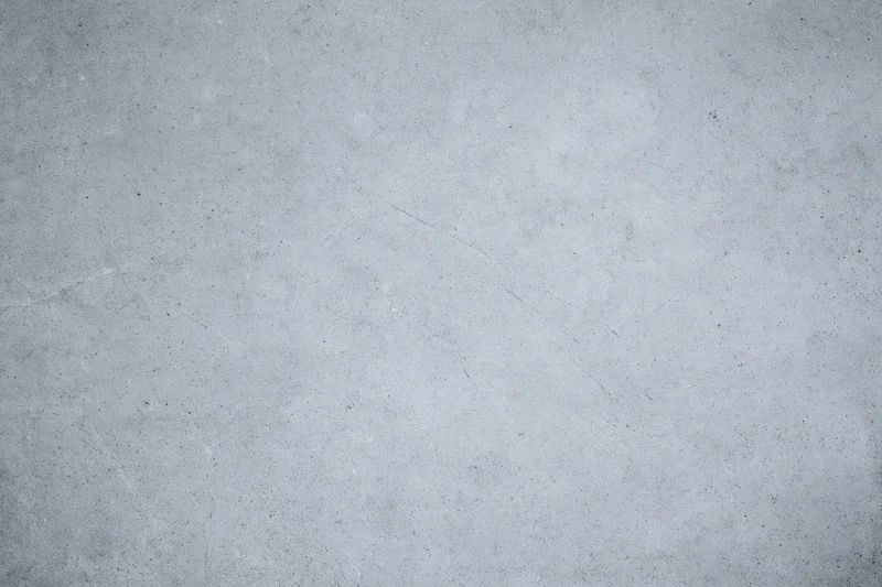 Close-up of a gray concrete wall surface with rough texture and subtle cracks