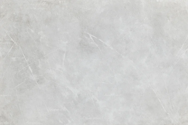 Close-up of a gray concrete wall surface with visible texture and scratches