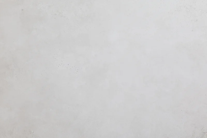 Flat concrete wall surface filling the frame with subtle texture and gray tone