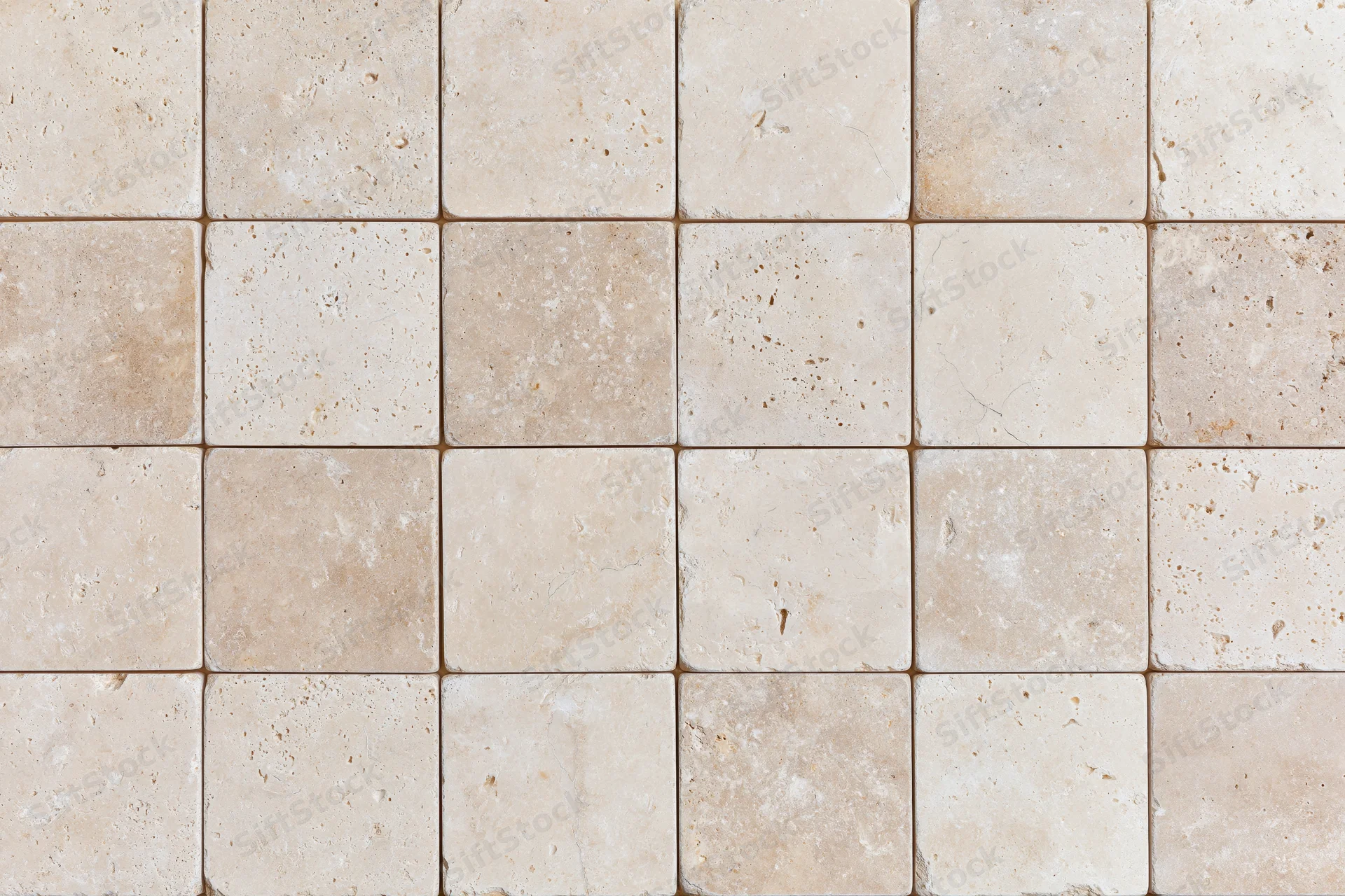 Travertine stone tiles arranged in a grid pattern for interior flooring or wall covering