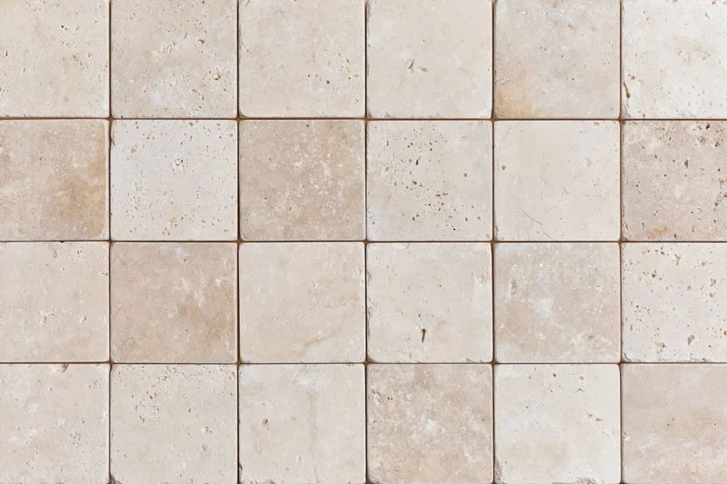 Travertine stone tiles arranged in a grid pattern for interior flooring or wall covering