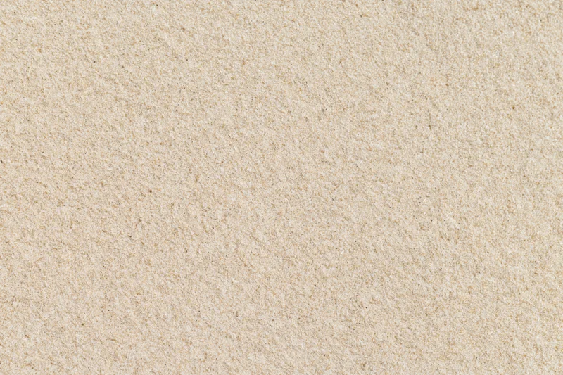 Close-up of smooth beach sand surface filling the frame