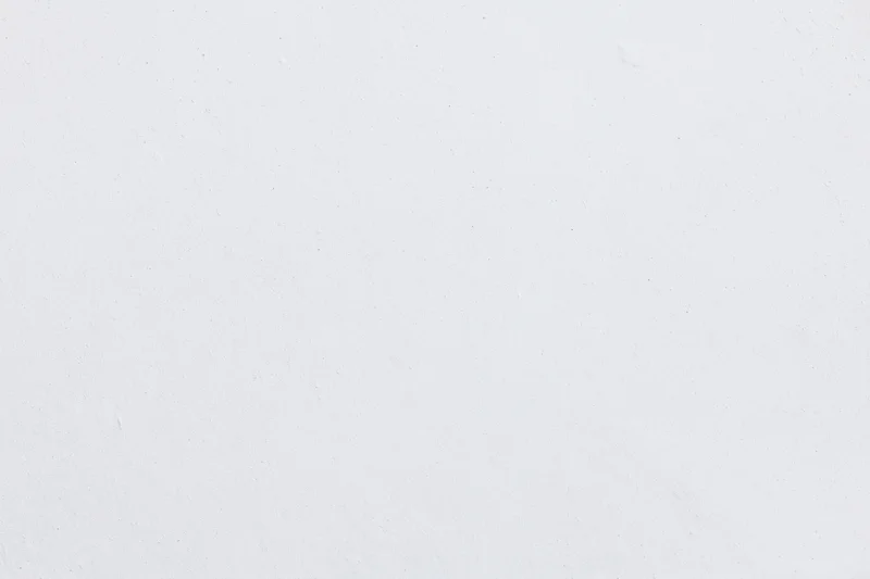 Close-up of a smooth white plaster wall surface with subtle texture