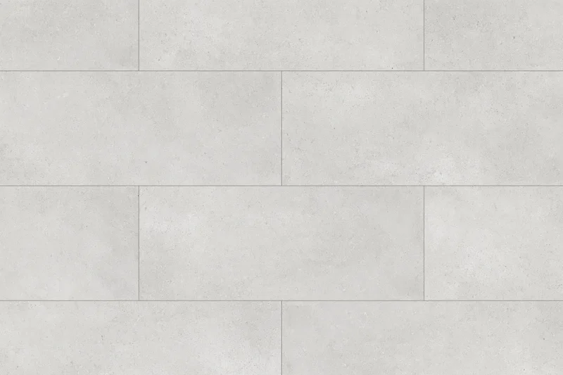 Large-format light grey concrete tiles arranged in a staggered pattern on a floor