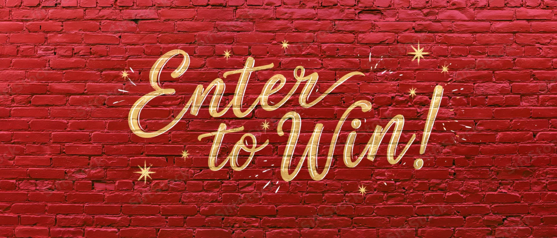 Gold calligraphy text reading enter to win on red brick wall with stars and sparkles