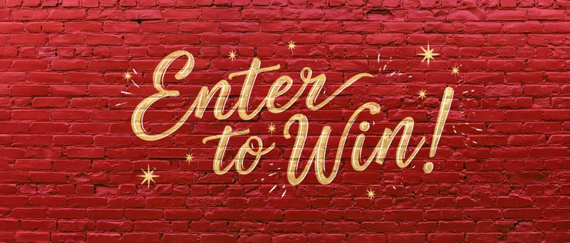 Gold calligraphy text reading enter to win on red brick wall with stars and sparkles