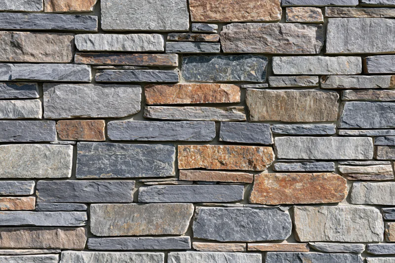 Stacked ledge stone wall filling the frame with natural texture and horizontal layers