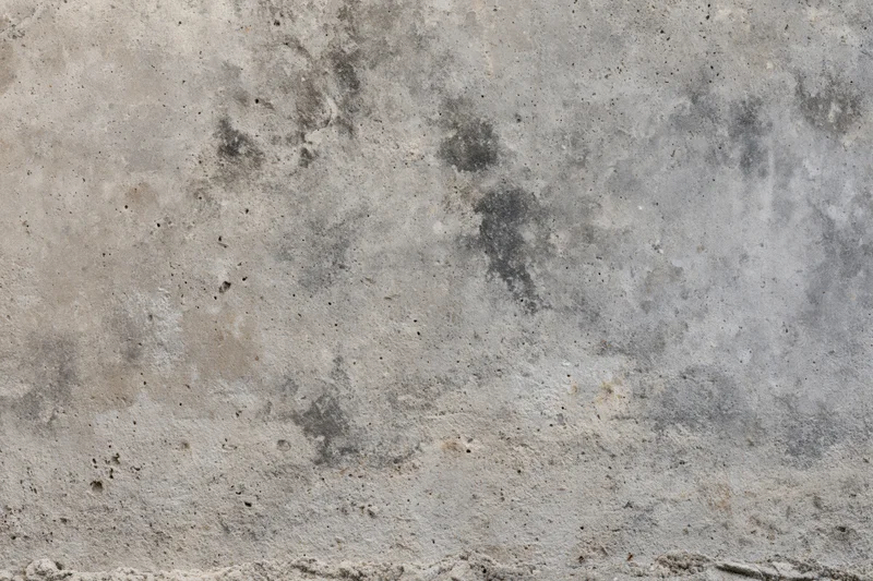 Weathered concrete surface filling the frame with rough texture and gray tones