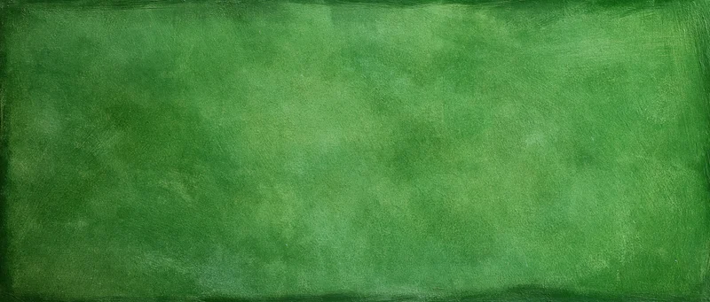 Weathered green painted wall surface filling the frame